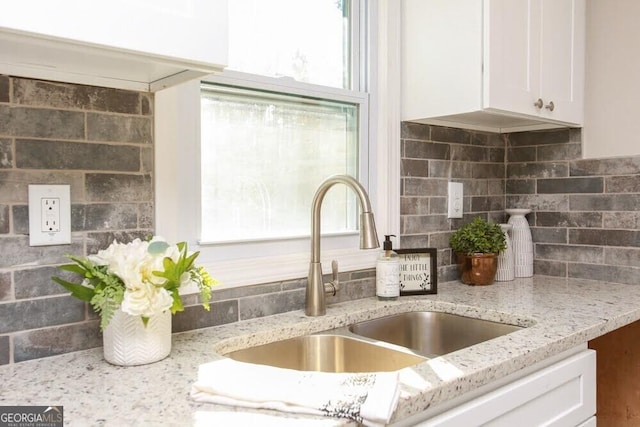 272 Old Sudie Rd, Hiram, GA 30141 - kitchen view of white cabinetry, light stone countertops, and decorative backsplash