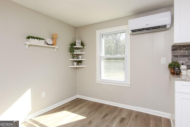 272 Old Sudie Rd, Hiram, GA 30141 - unfurnished dining area with a wall mounted AC and wood finished floors