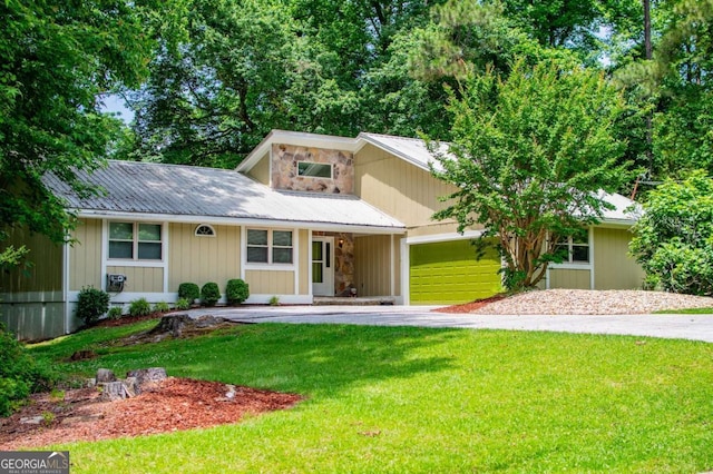 7358 S Mitchell Ct, Villa Rica, GA 30180 - view of front of house featuring a front yard, stone siding, metal roof, and an attached garage