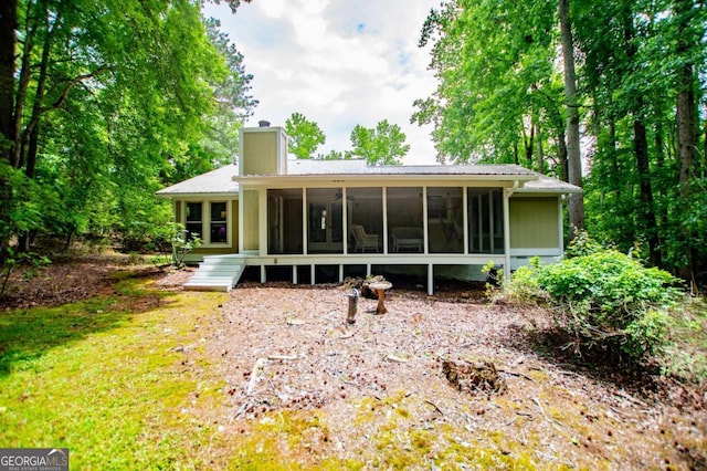 7358 S Mitchell Ct, Villa Rica, GA 30180 - rear view of house with a chimney and a sunroom