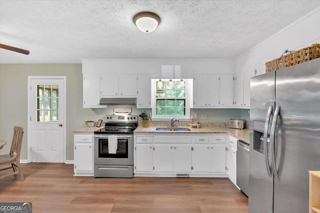 1277 Abrams Rd SE, Silver Creek, GA 30173 - kitchen featuring stainless steel appliances, a sink, under cabinet range hood, white cabinets, and light wood finished floors