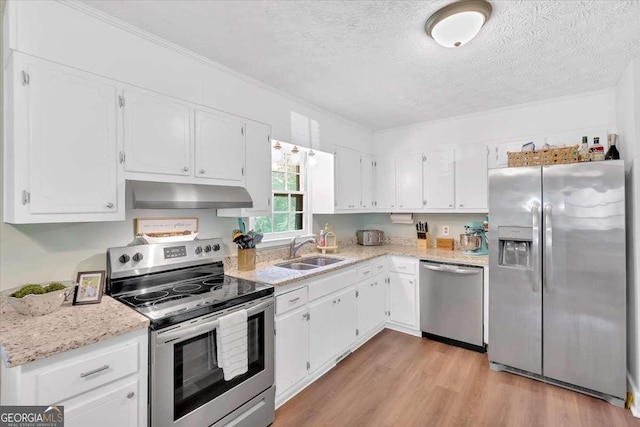 1277 Abrams Rd SE, Silver Creek, GA 30173 - kitchen featuring appliances with stainless steel finishes, under cabinet range hood, a sink, white cabinetry, and a textured ceiling