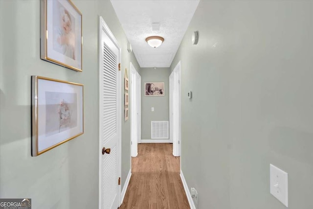 1277 Abrams Rd SE, Silver Creek, GA 30173 - corridor with wood finished floors, attic access, and baseboards