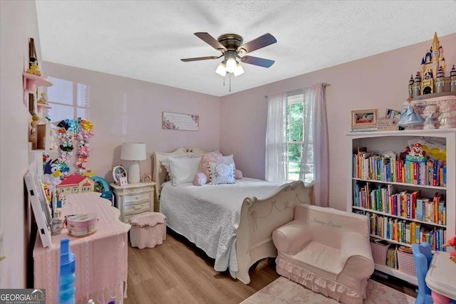 1277 Abrams Rd SE, Silver Creek, GA 30173 - bedroom with wood finished floors, ceiling fan, and a textured ceiling