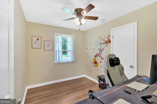 1277 Abrams Rd SE, Silver Creek, GA 30173 - home office with wood finished floors, ceiling fan, and baseboards