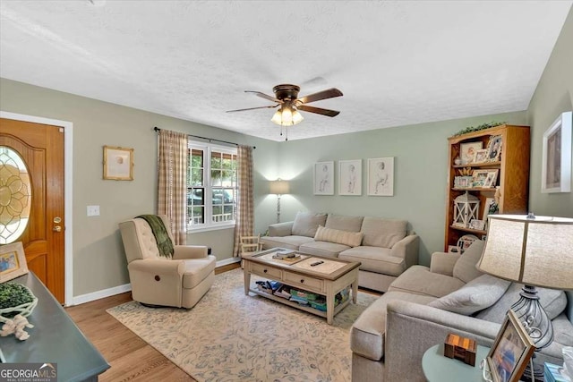 1277 Abrams Rd SE, Silver Creek, GA 30173 - living area featuring a ceiling fan, wood finished floors, baseboards, and a textured ceiling