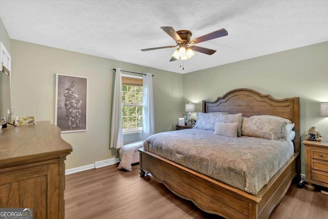 1277 Abrams Rd SE, Silver Creek, GA 30173 - bedroom with wood finished floors, baseboards, ceiling fan, and a textured ceiling