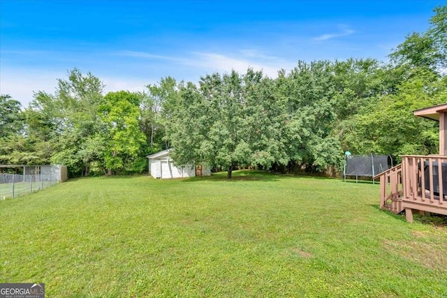 1277 Abrams Rd SE, Silver Creek, GA 30173 - view of yard with a trampoline, an outbuilding, and view of wooded area