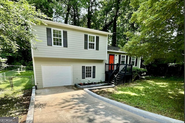 840 Wells Cir SE, Smyrna, GA 30080 - split level home featuring an attached garage, driveway, and view of scattered trees
