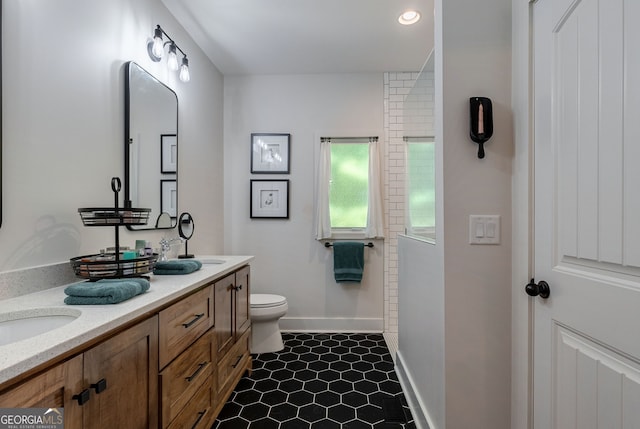 724 Bertha Willis Rd, Carlton, GA 30627 - full bath featuring double vanity, toilet, baseboards, tile patterned flooring, and recessed lighting