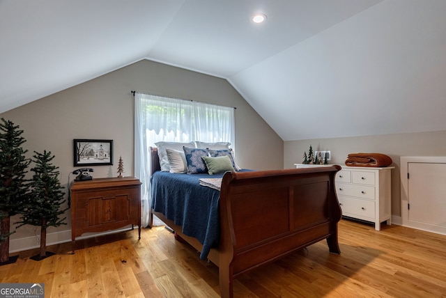 724 Bertha Willis Rd, Carlton, GA 30627 - bedroom with light wood finished floors, lofted ceiling, and baseboards
