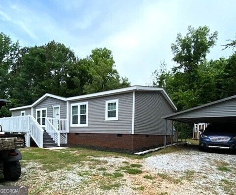 724 Bertha Willis Rd, Carlton, GA 30627 - view of property exterior with crawl space, driveway, and a wooden deck