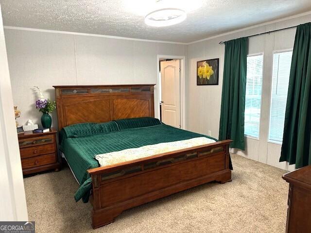 724 Bertha Willis Rd, Carlton, GA 30627 - carpeted bedroom featuring a textured ceiling and ornamental molding
