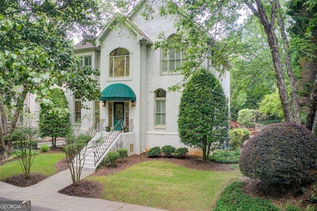 42 Greenland Trce, Atlanta, GA 30342 - view of front facade with stucco siding and a front yard