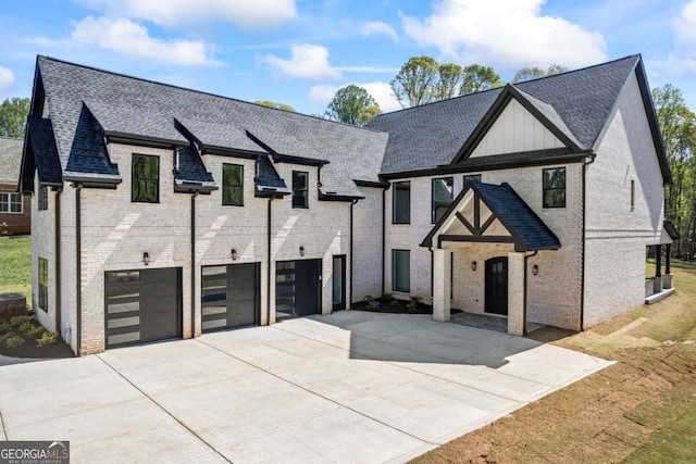 407 Thunder Rd, Buford, GA 30518 - view of front of home featuring a garage, concrete driveway, brick siding, and a shingled roof