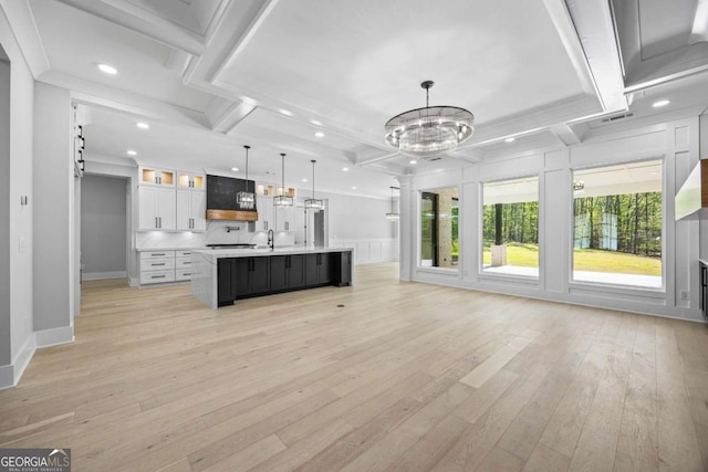 407 Thunder Rd, Buford, GA 30518 - unfurnished living room with light wood-style floors, recessed lighting, a chandelier, coffered ceiling, and beamed ceiling