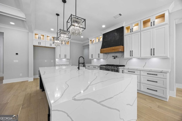 407 Thunder Rd, Buford, GA 30518 - kitchen with custom range hood, recessed lighting, high end range, white cabinets, and light wood-style flooring