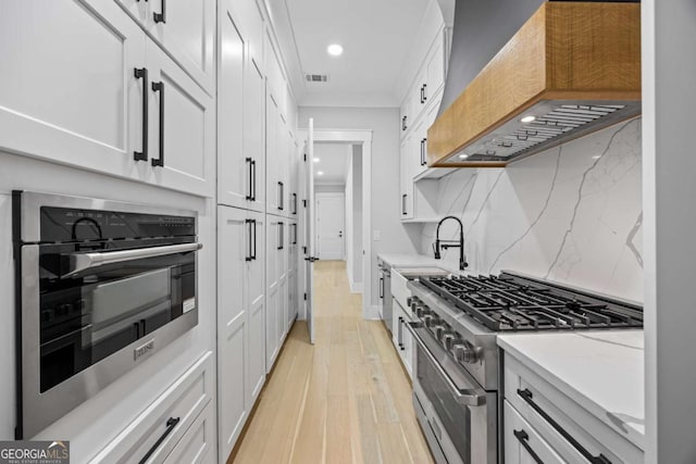 407 Thunder Rd, Buford, GA 30518 - kitchen with premium range hood, appliances with stainless steel finishes, light wood finished floors, recessed lighting, and white cabinets