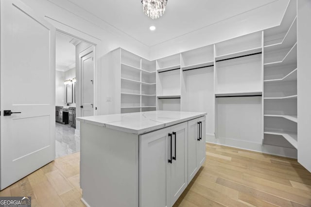 407 Thunder Rd, Buford, GA 30518 - spacious closet featuring light wood-style floors and a chandelier