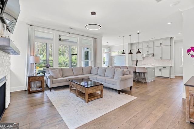 229 Widener Way, Peachtree City, GA 30269 - living area with a ceiling fan, recessed lighting, a brick fireplace, light wood-style floors, and baseboards