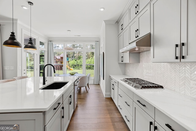 229 Widener Way, Peachtree City, GA 30269 - kitchen featuring under cabinet range hood, stainless steel appliances, light countertops, tasteful backsplash, and wood finished floors