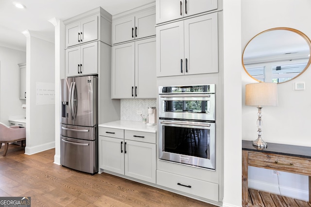 229 Widener Way, Peachtree City, GA 30269 - kitchen with appliances with stainless steel finishes, light wood finished floors, tasteful backsplash, light countertops, and baseboards