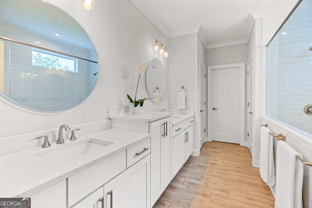 229 Widener Way, Peachtree City, GA 30269 - bathroom featuring double vanity, a tile shower, wood finished floors, and ornamental molding
