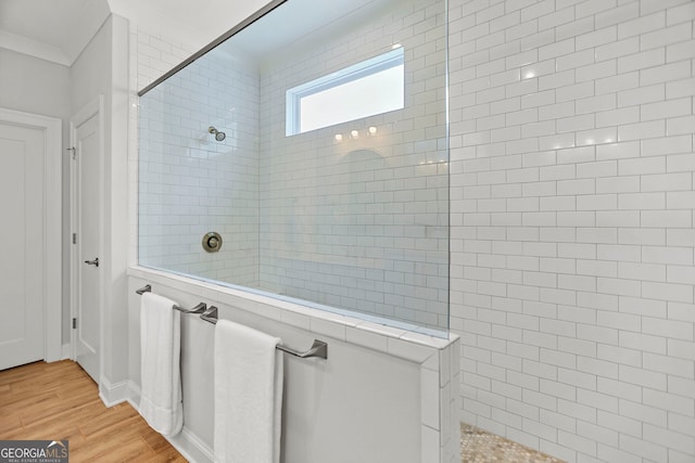 229 Widener Way, Peachtree City, GA 30269 - bathroom with a walk in shower, wood finished floors, and crown molding
