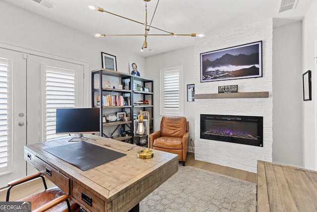 229 Widener Way, Peachtree City, GA 30269 - office space featuring wood finished floors, a fireplace, and a chandelier
