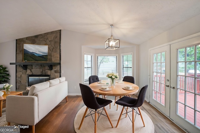 4191 Alaina Cir, Austell, GA 30106 - dining space with vaulted ceiling, plenty of natural light, wood finished floors, and a chandelier