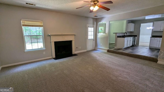 3881 Micah Ln, Ellenwood, GA 30294 - unfurnished living room featuring ceiling fan, dark carpet, a textured ceiling, and baseboards