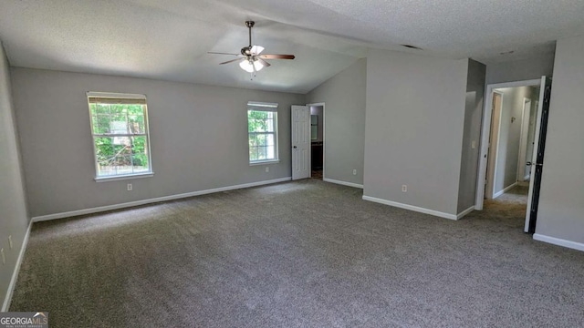 3881 Micah Ln, Ellenwood, GA 30294 - carpeted spare room with ceiling fan, baseboards, vaulted ceiling, and a textured ceiling