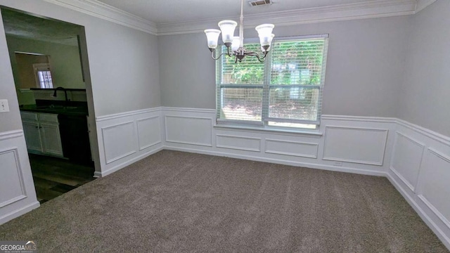 3881 Micah Ln, Ellenwood, GA 30294 - empty room with a chandelier, ornamental molding, wainscoting, dark colored carpet, and a decorative wall