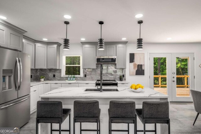 681 Fielding Ln SW, Atlanta, GA 30311 - kitchen featuring appliances with stainless steel finishes, gray cabinetry, tasteful backsplash, healthy amount of natural light, and recessed lighting