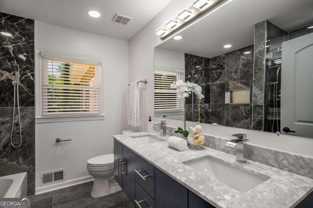 681 Fielding Ln SW, Atlanta, GA 30311 - full bath featuring double vanity, wood finished floors, recessed lighting, and radiator