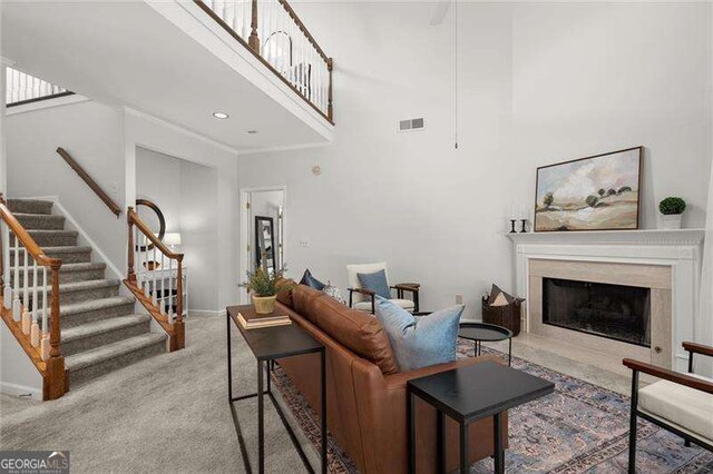 1050 Shady Valley Pl, Atlanta, GA 30324 - carpeted living room with stairway, a high ceiling, baseboards, and a premium fireplace