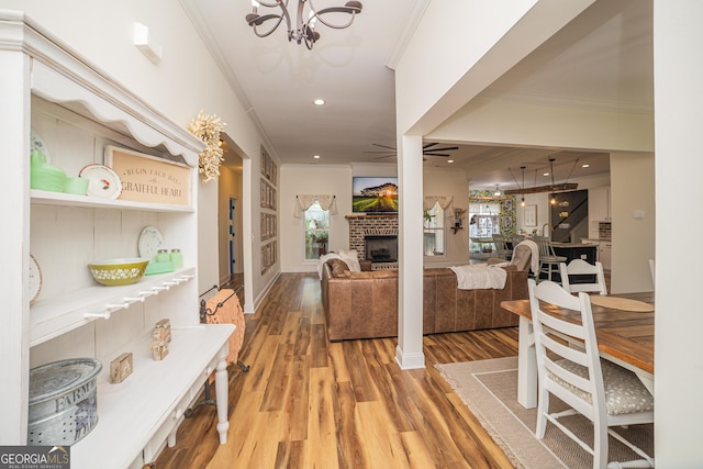 115 Lanier Loop, Kathleen, GA 31047 - living room featuring ornamental molding, light wood-style floors, a fireplace, plenty of natural light, and a chandelier