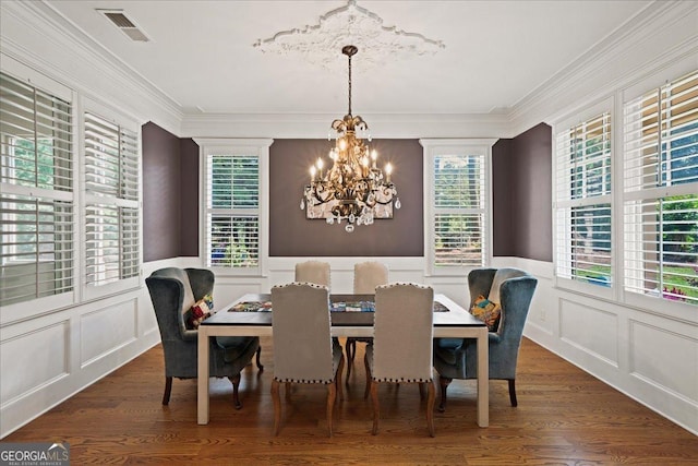 1323 Frey Lake Ct NW, Kennesaw, GA 30144 - dining space with a chandelier, a decorative wall, dark wood finished floors, crown molding, and a wainscoted wall