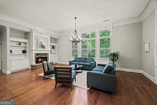 1323 Frey Lake Ct NW, Kennesaw, GA 30144 - living area featuring ornamental molding, a stone fireplace, wood finished floors, baseboards, and a chandelier