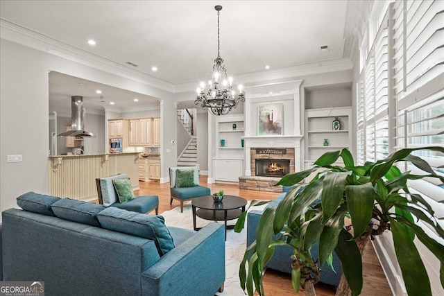 1323 Frey Lake Ct NW, Kennesaw, GA 30144 - living area featuring light wood-style flooring, stairs, recessed lighting, a chandelier, and a fireplace