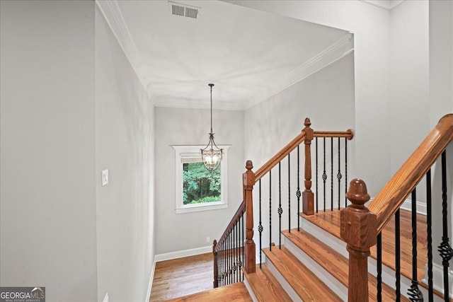 1323 Frey Lake Ct NW, Kennesaw, GA 30144 - stairway with a chandelier, wood finished floors, baseboards, and ornamental molding