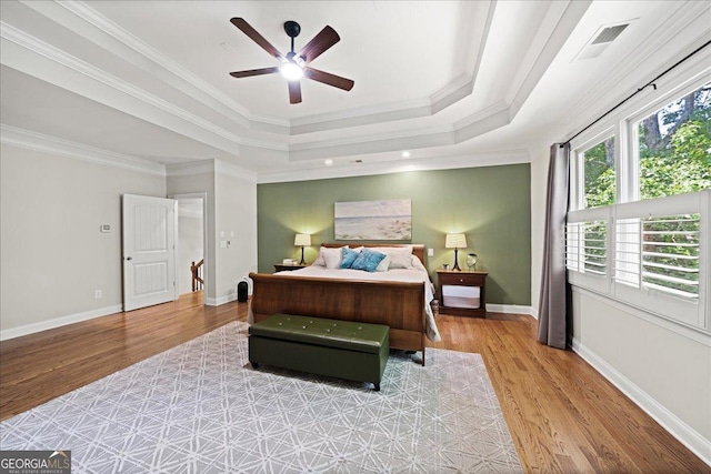 1323 Frey Lake Ct NW, Kennesaw, GA 30144 - bedroom featuring light wood-type flooring, a raised ceiling, crown molding, and baseboards