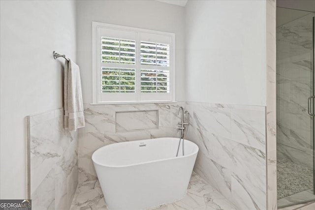 1323 Frey Lake Ct NW, Kennesaw, GA 30144 - bathroom with a marble finish shower, marble tiled floors, a freestanding tub, tile walls, and a wainscoted wall