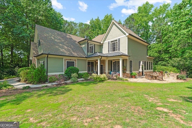 1323 Frey Lake Ct NW, Kennesaw, GA 30144 - view of front of home featuring a standing seam roof, a fire pit, a front yard, and covered porch