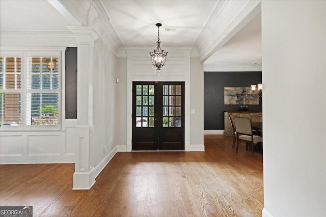 1323 Frey Lake Ct NW, Kennesaw, GA 30144 - foyer featuring french doors, a chandelier, wood finished floors, ornate columns, and ornamental molding