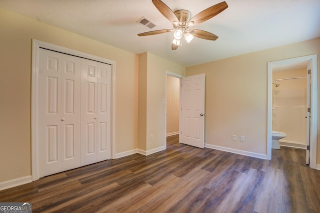 170 Hidden Pines Dr, Covington, GA 30016 - unfurnished bedroom with dark wood-style flooring, a closet, and baseboards