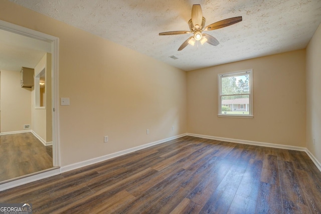 170 Hidden Pines Dr, Covington, GA 30016 - unfurnished room featuring dark wood-type flooring, a ceiling fan, baseboards, and a textured ceiling