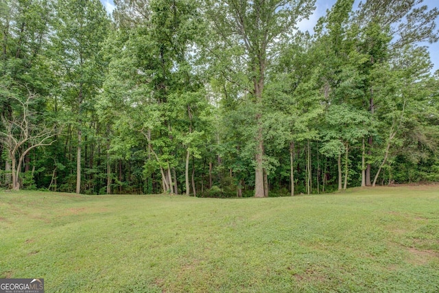 170 Hidden Pines Dr, Covington, GA 30016 - view of green lawn featuring a wooded view