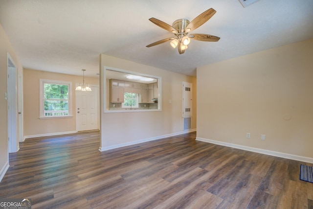 170 Hidden Pines Dr, Covington, GA 30016 - unfurnished living room with a ceiling fan, dark wood-style floors, a chandelier, and baseboards