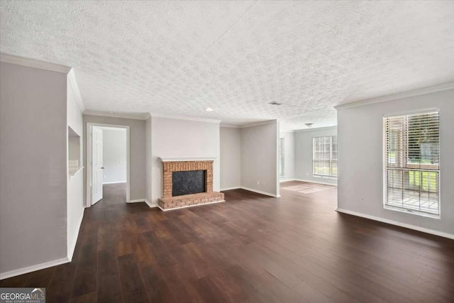 5555 Mountain Springs Cir, Stone Mountain, GA 30088 - unfurnished living room with crown molding, dark wood-style flooring, a brick fireplace, and a textured ceiling